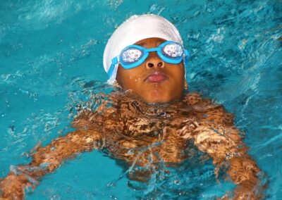 Junger Schwimmer mit badekappe und brille